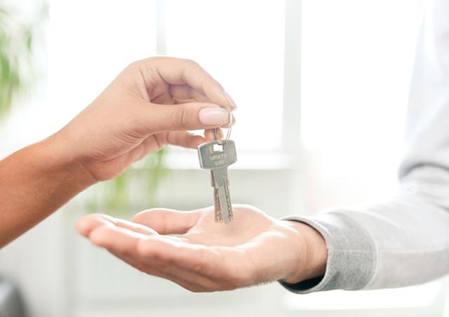 one-person-handing-over-keys-to-another-person